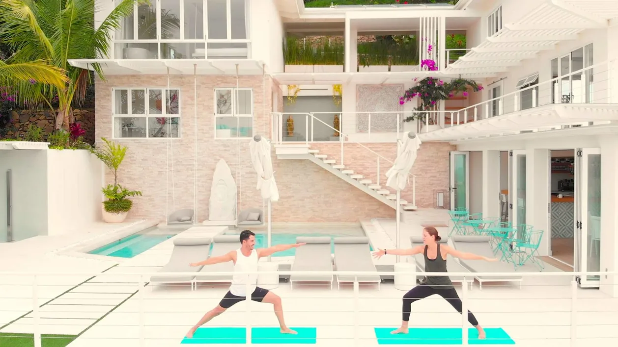 The Retreat Costa Rica warrior two yoga pose pool deck